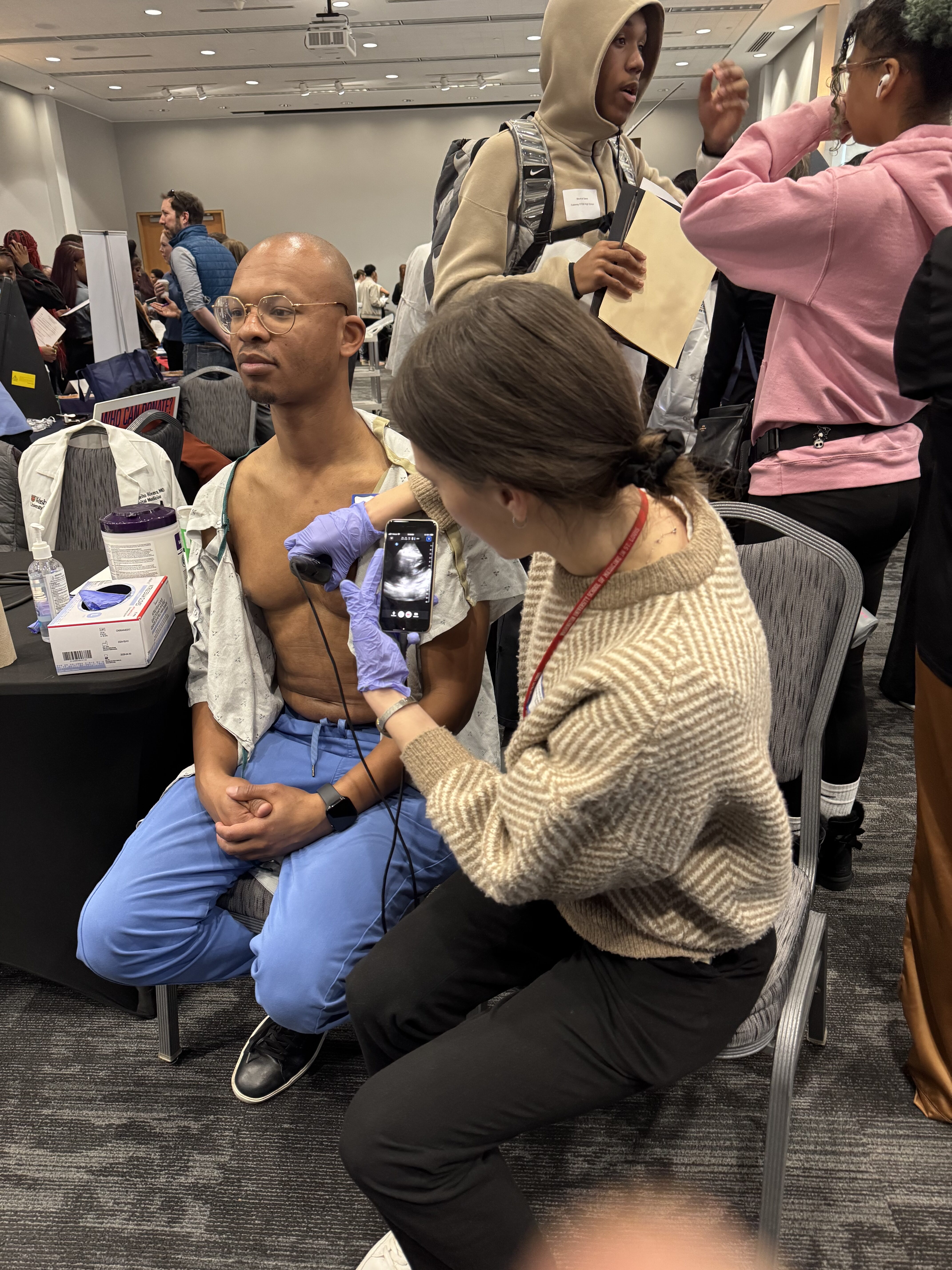 Student looks at Dr. Corey Shy's heart using an ultrasound device 